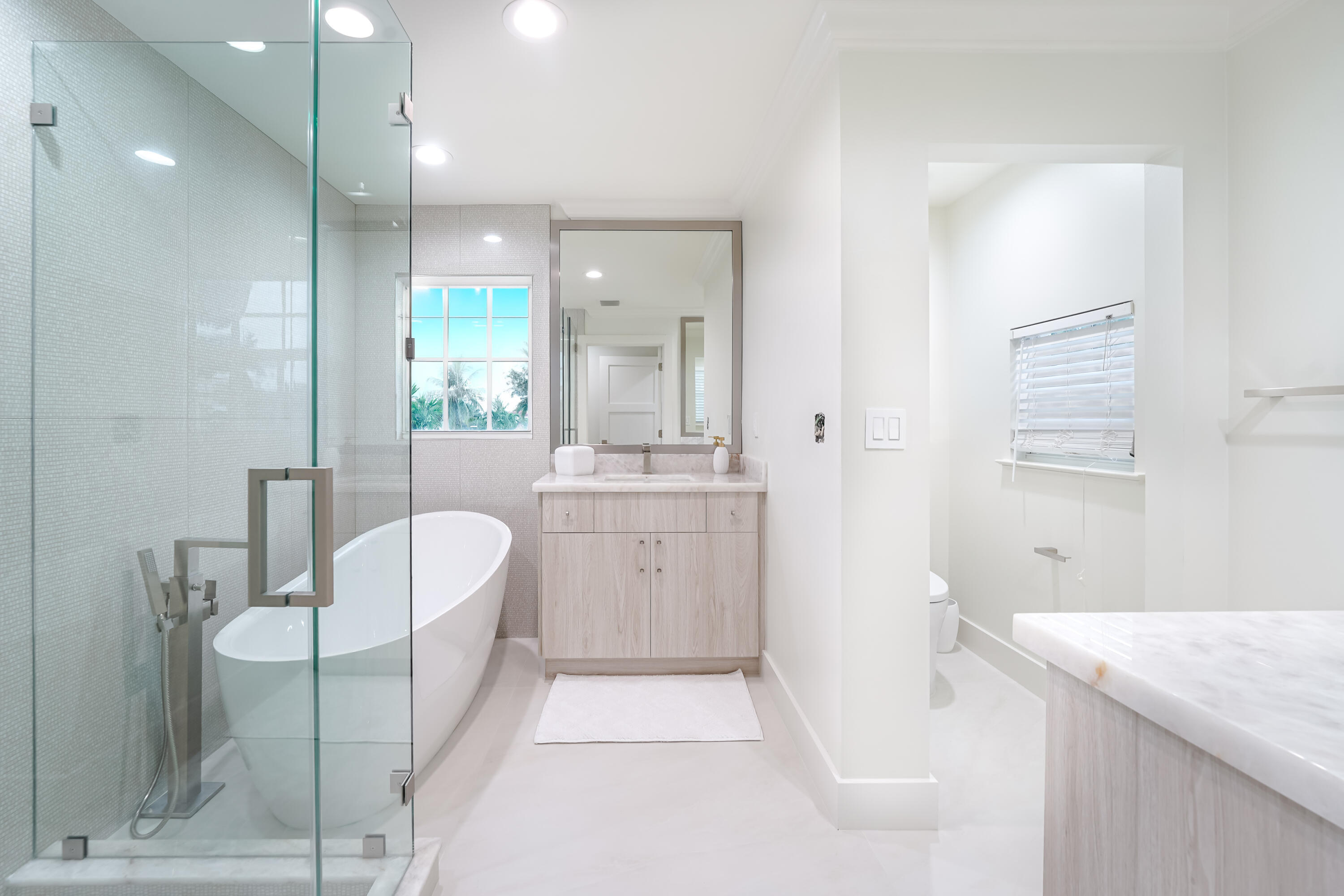 749 Northeast 71st Street Boca Raton, FL 33487 - Photo 37 of 43 a bathroom with a granite countertop sink a toilet a mirror and bathtub