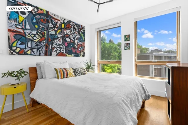 a bed sitting in a bedroom next to a window