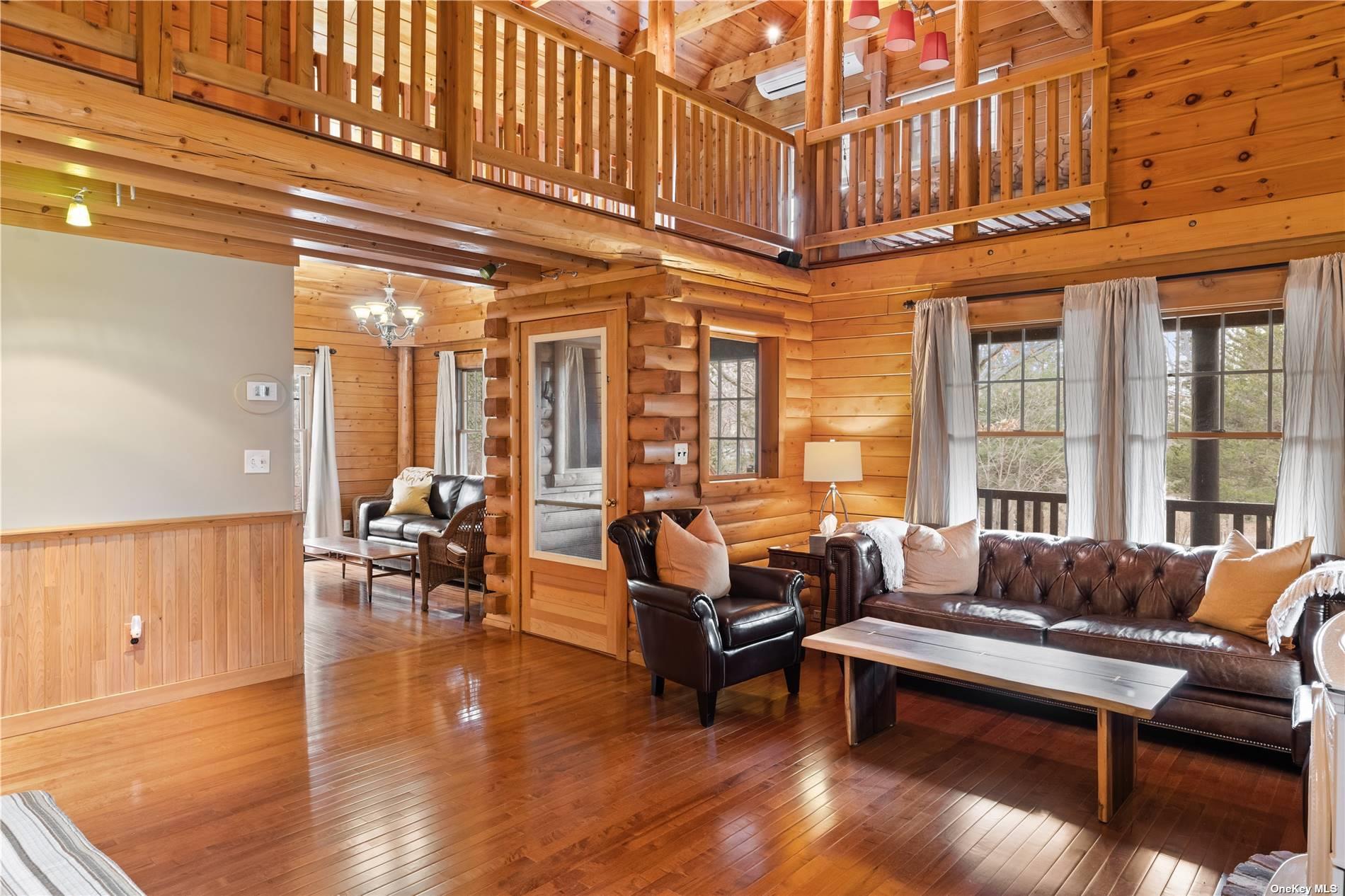 380 Private Road Southold, NY 11971 - Photo 13 of 31 a living room with furniture a wooden floor and a potted plant