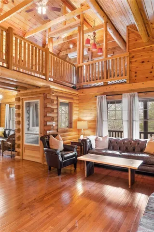 a living room with furniture windows and wooden floor