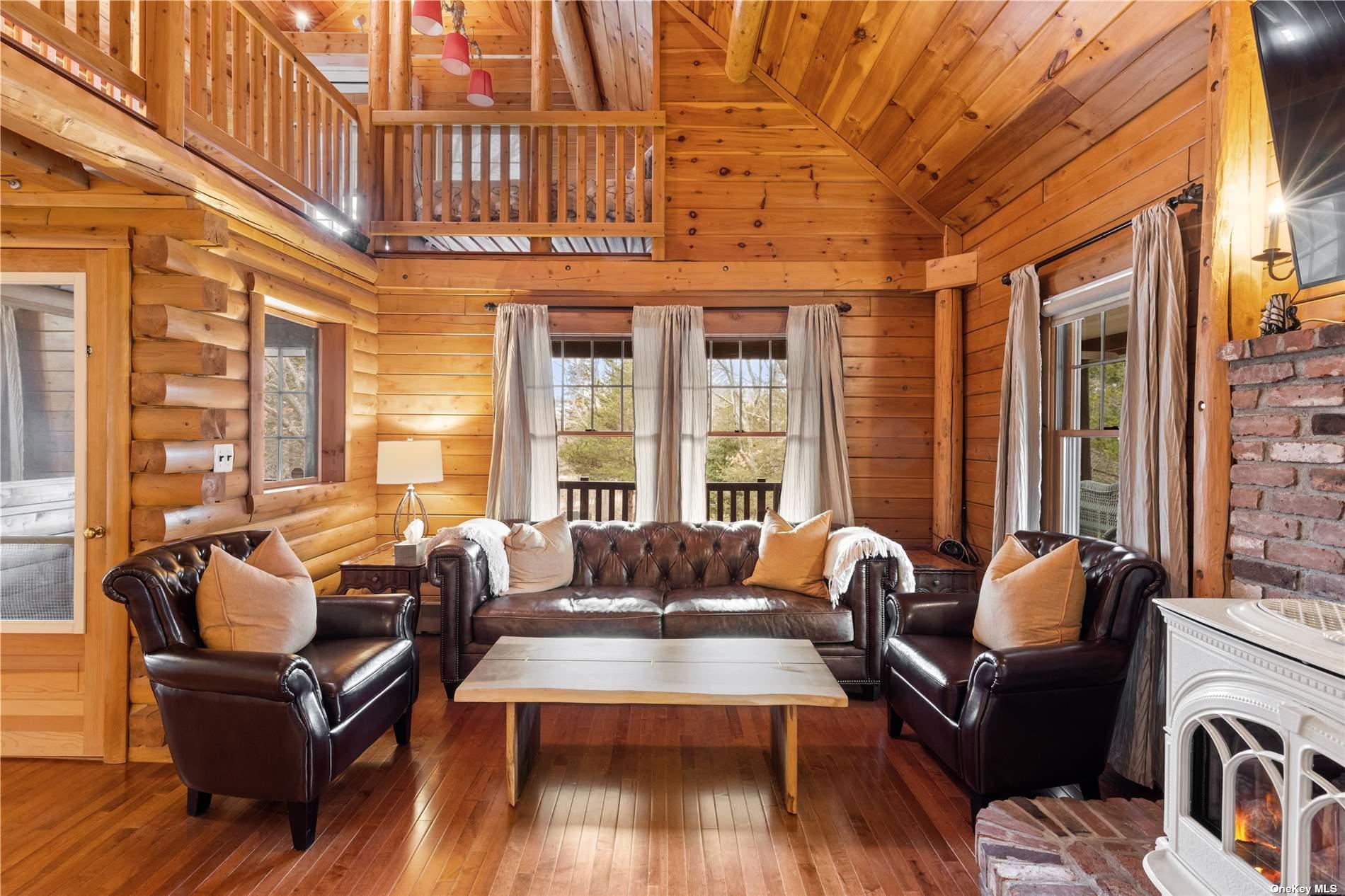 380 Private Road Southold, NY 11971 - Photo 15 of 31 a living room with furniture windows and wooden floor