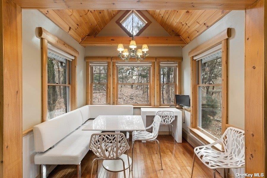 380 Private Road Southold, NY 11971 - Photo 16 of 31 a view of a dining room with furniture wooden floor and chandelier