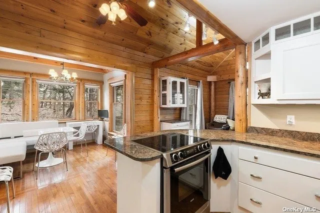 a view of entryway livingroom and hall with wooden floor
