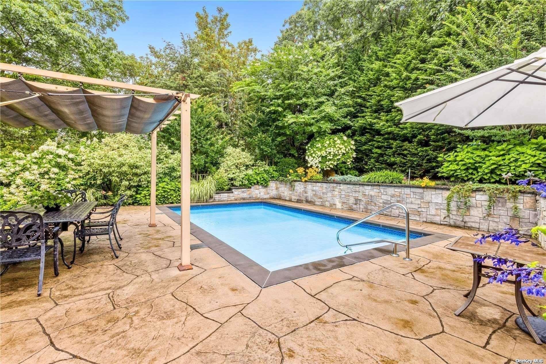 380 Private Road Southold, NY 11971 - Photo 2 of 31 a view of backyard with swimming pool and outdoor seating