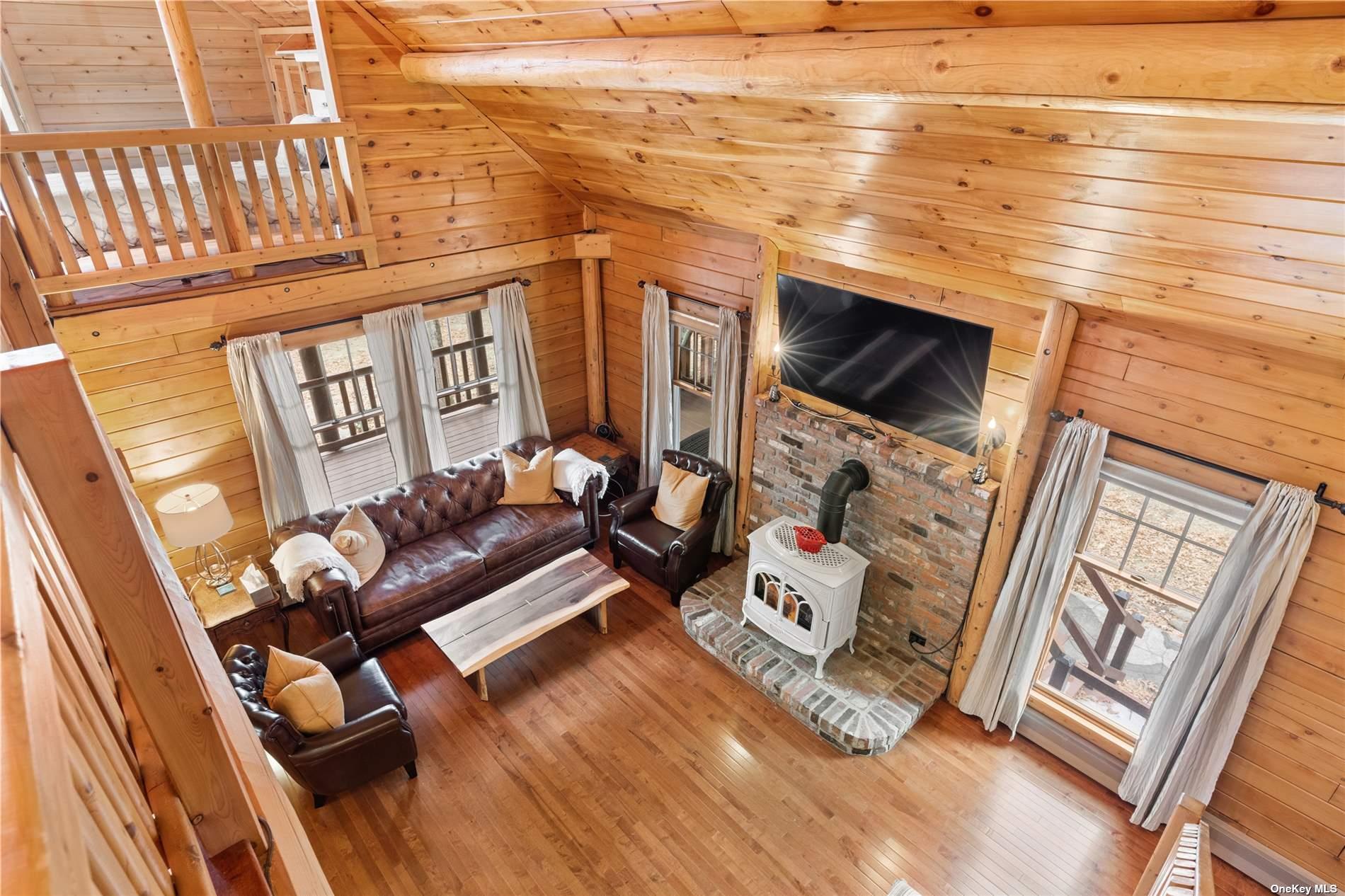 380 Private Road Southold, NY 11971 - Photo 22 of 31 a living room with furniture and a flat screen tv