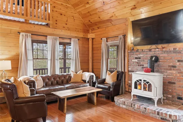 a living room with furniture fireplace and flat screen tv
