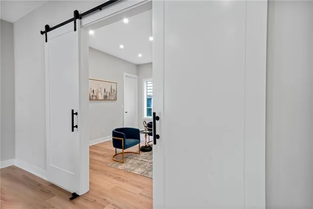 a bed sitting in a spacious bedroom next to a window