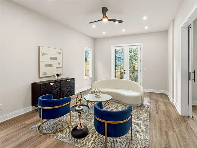 a kitchen with granite countertop a sink cabinets and wooden floor