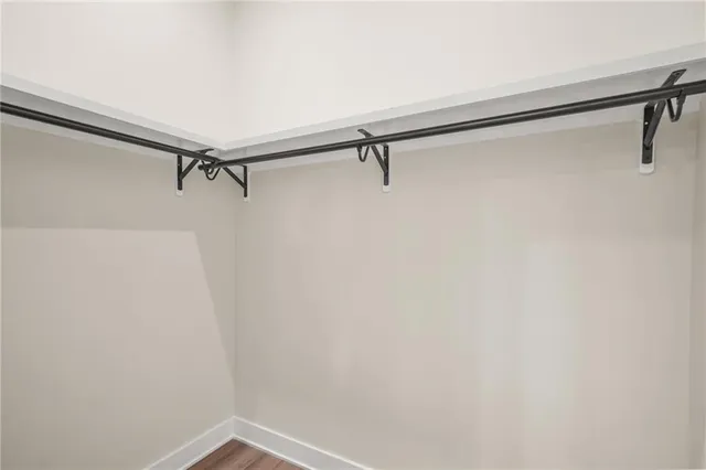 a kitchen with kitchen island a sink and a stove top oven with wooden floor