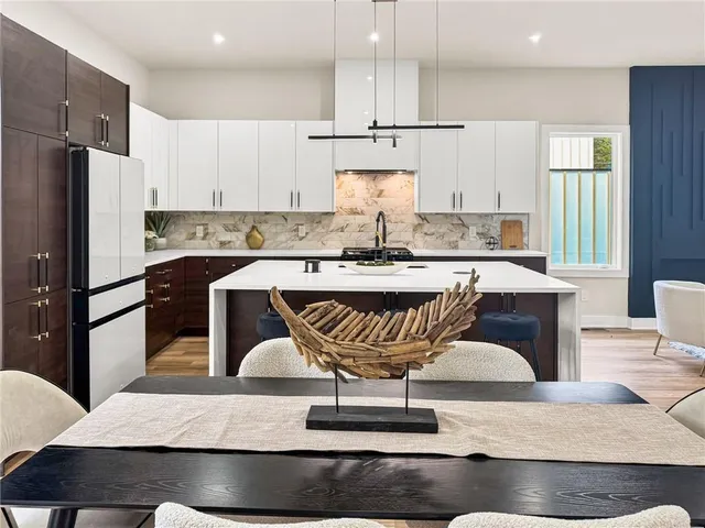 a kitchen with stainless steel appliances granite countertop a sink a stove and cabinets