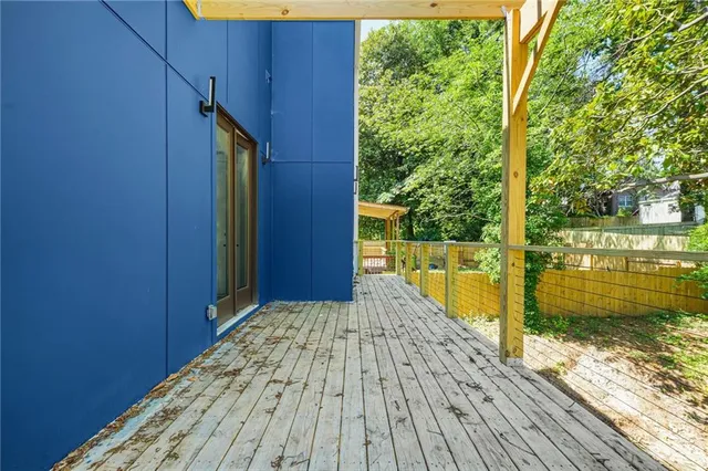 a bed sitting in a bedroom next to a window with potted plants