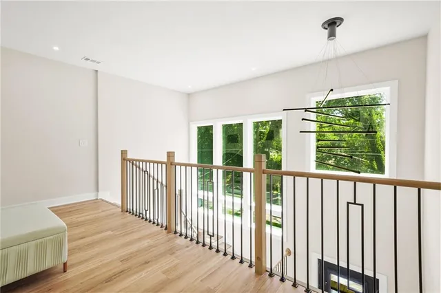 a view of a hallway with wooden floor