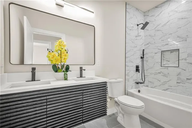 a bathroom with a sink a toilet and a shower