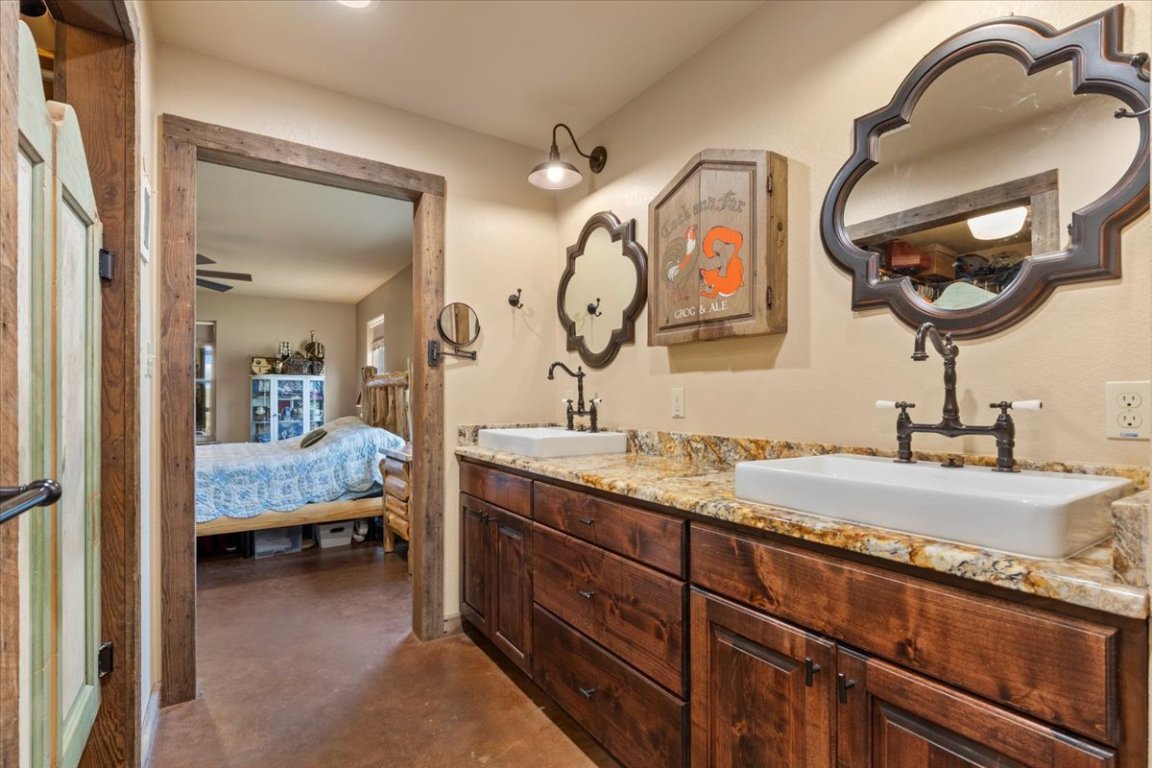 7835 Berger Road Schulenburg, TX 78956 - Photo 15 of 40 Ensuite bathroom featuring finished concrete flooring and double vanity