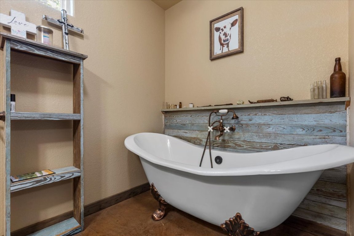 7835 Berger Road Schulenburg, TX 78956 - Photo 20 of 40 Bathroom featuring a textured wall and a freestanding tub