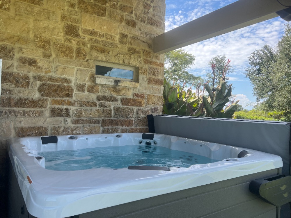 7835 Berger Road Schulenburg, TX 78956 - Photo 28 of 40 Exterior view of stone siding and a hot tub