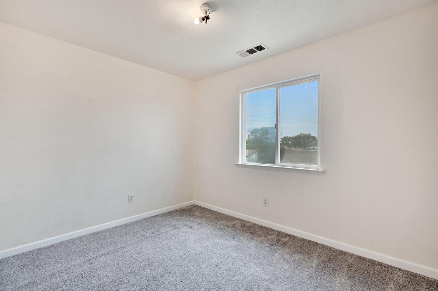2061 Seventh Street Fresno, CA 93702 - Photo 15 of 38 an empty room with a window