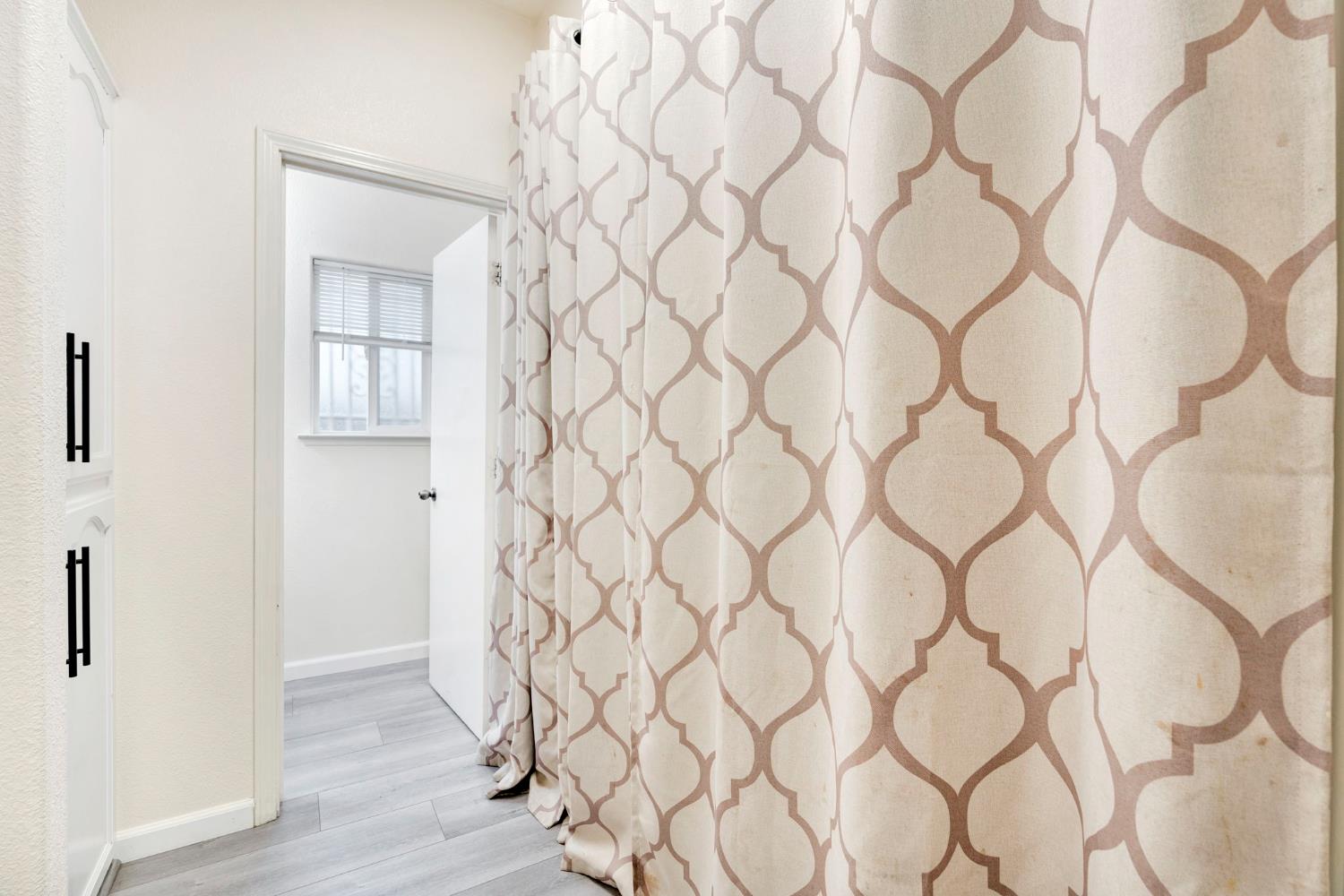 2061 Seventh Street Fresno, CA 93702 - Photo 17 of 38 a view of a white wall with exposed radiator and a wooden floor