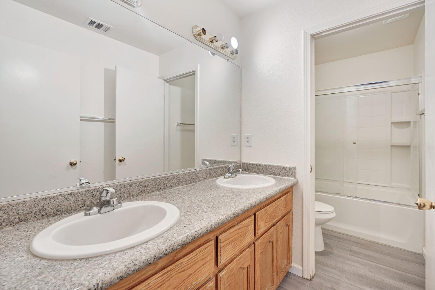 2061 Seventh Street Fresno, CA 93702 - Photo 19 of 38 a bathroom with a granite countertop sink and a mirror