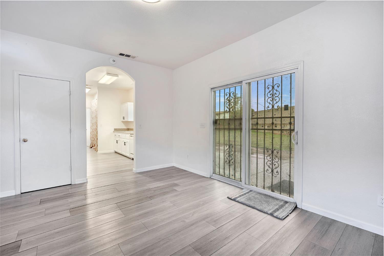 2061 Seventh Street Fresno, CA 93702 - Photo 23 of 38 an empty room with wooden floor and windows