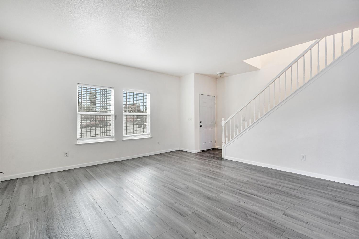 2061 Seventh Street Fresno, CA 93702 - Photo 26 of 38 a view of an empty room with wooden floor and a window