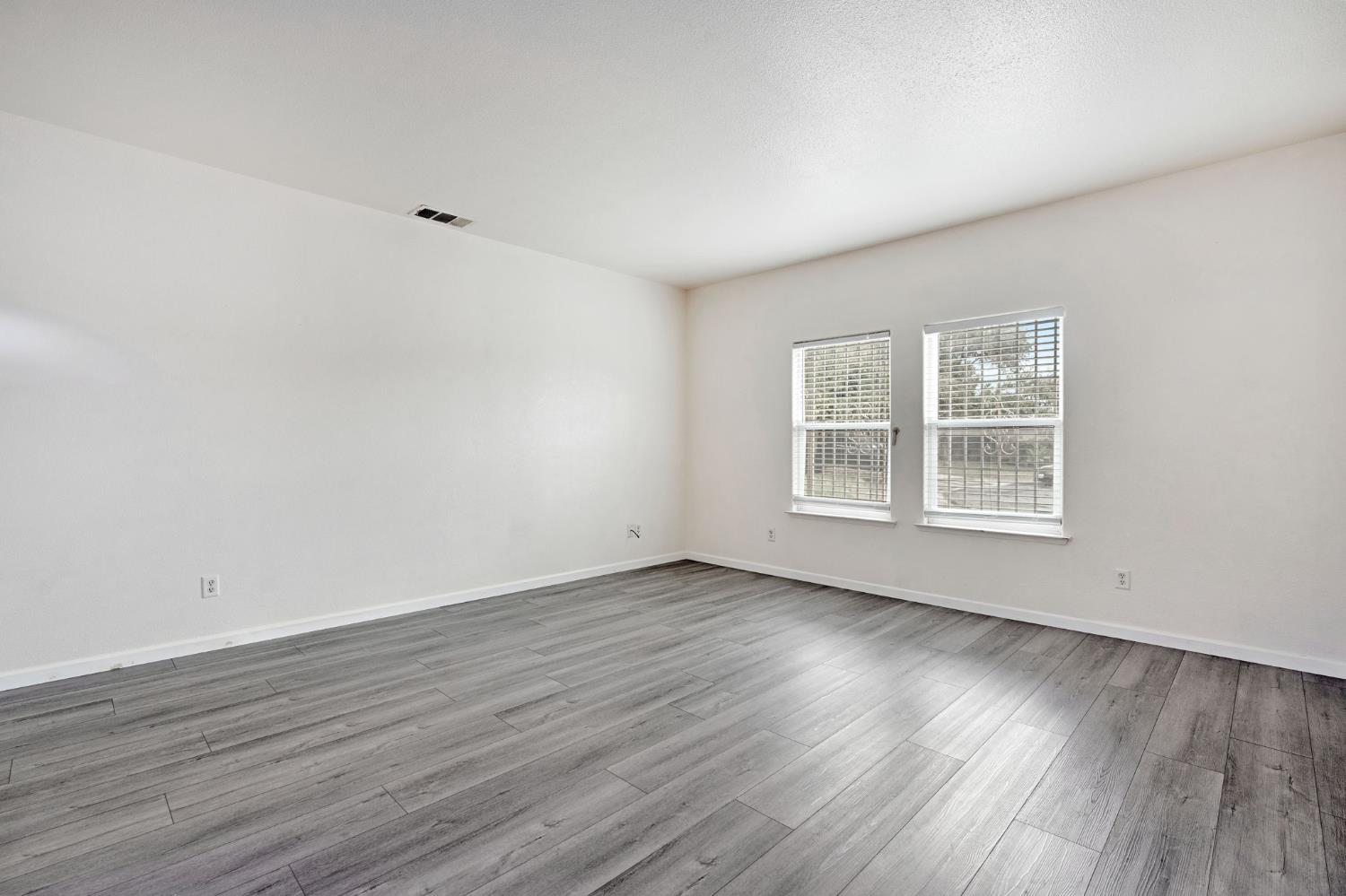 2061 Seventh Street Fresno, CA 93702 - Photo 27 of 38 a view of an empty room with wooden floor and a window
