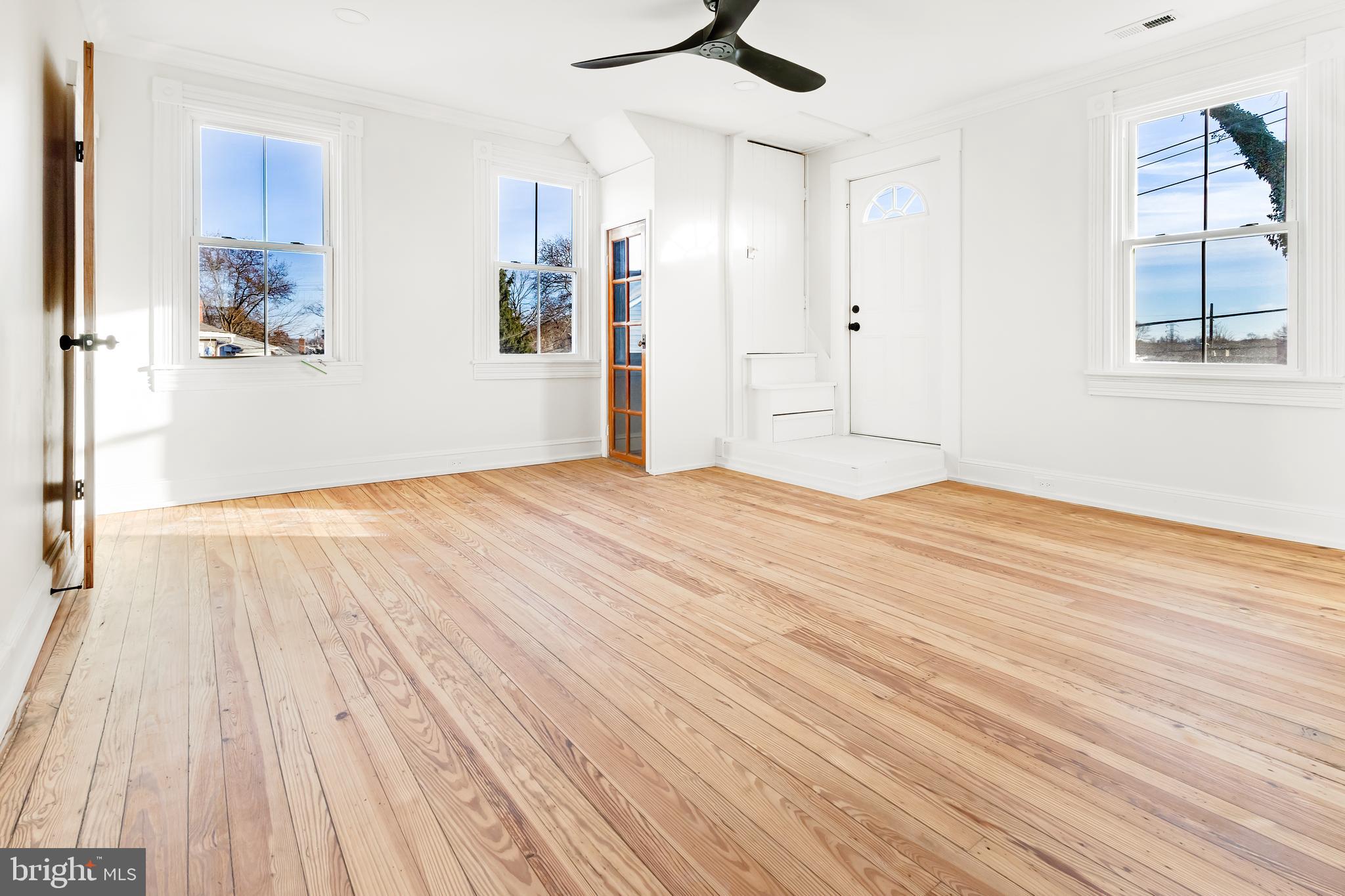 7714 Fairgreen Road Dundalk, MD 21222 - Photo 29 of 38 a view of empty room with wooden floor and fan