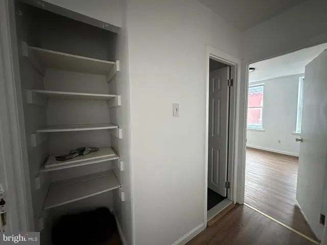 a view of walk in closet with empty racks
