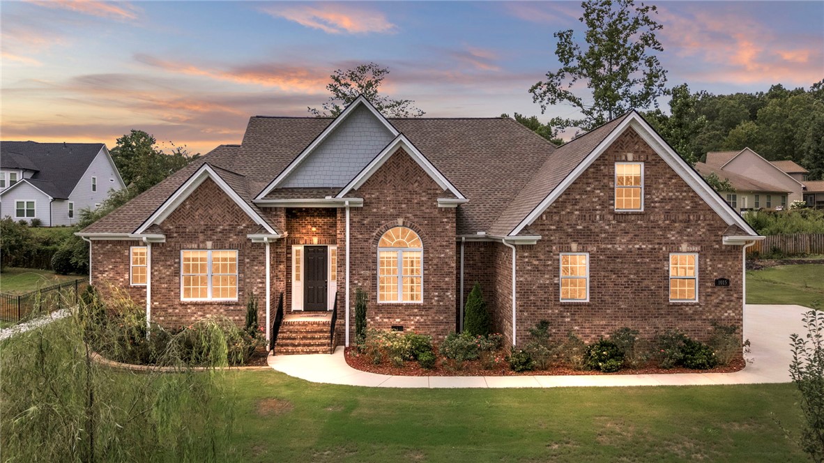 This classic brick residence features an inviting facade with well-maintained landscaping.