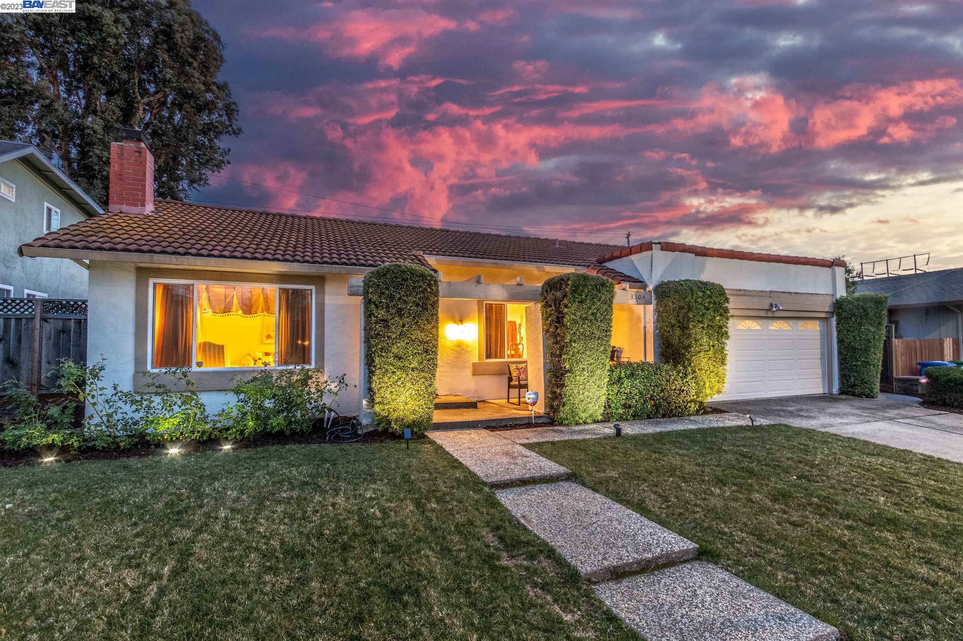 a view of a house with brick walls and a pathway