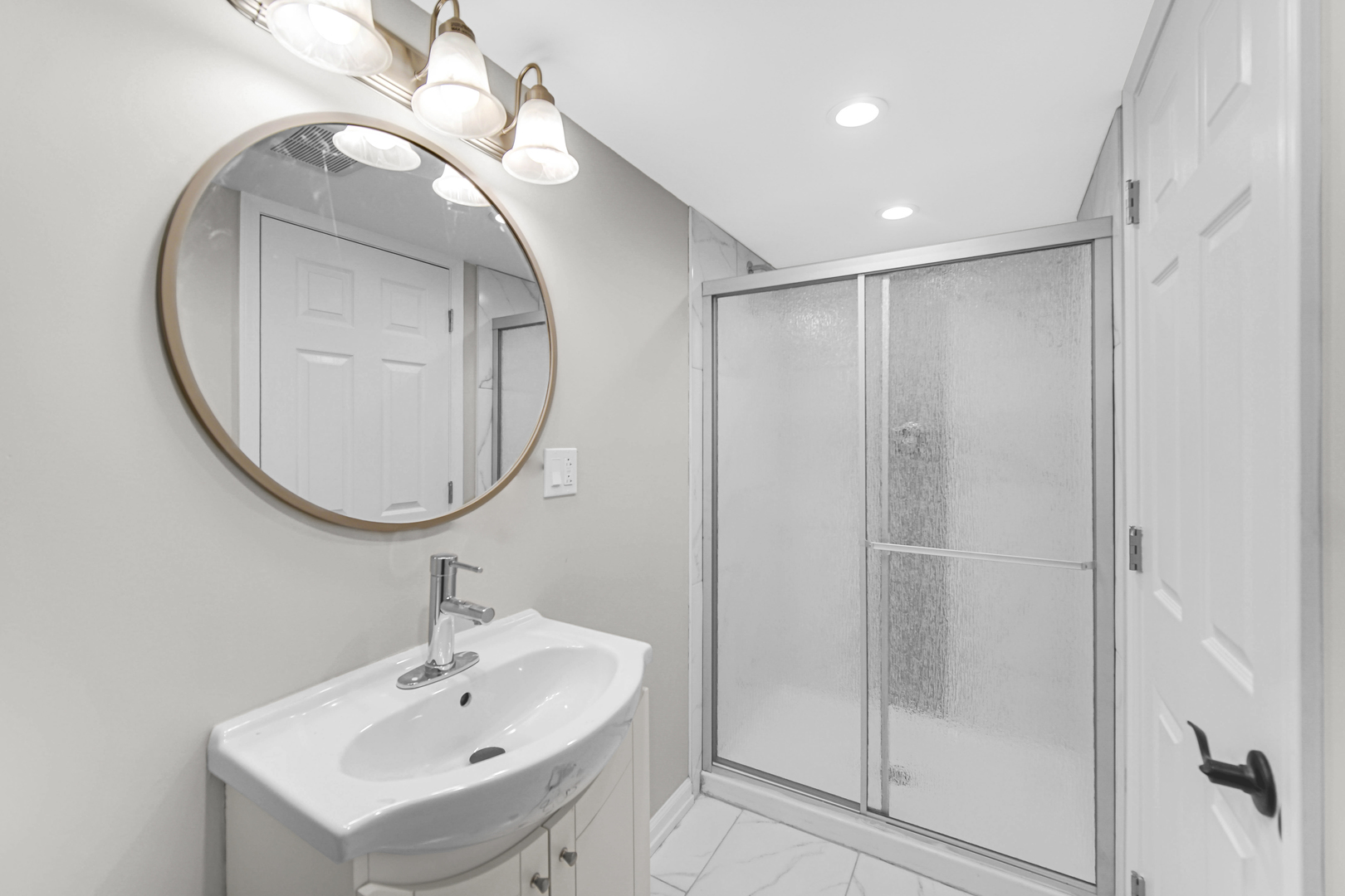 10328 South Union Avenue Chicago, IL 60628 - Photo 16 of 18 a bathroom with a sink a mirror a vanity and a shower
