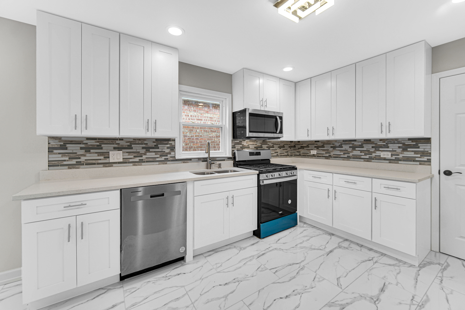 10328 South Union Avenue Chicago, IL 60628 - Photo 6 of 18 a kitchen with granite countertop white cabinets white stainless steel appliances with a sink and dishwasher