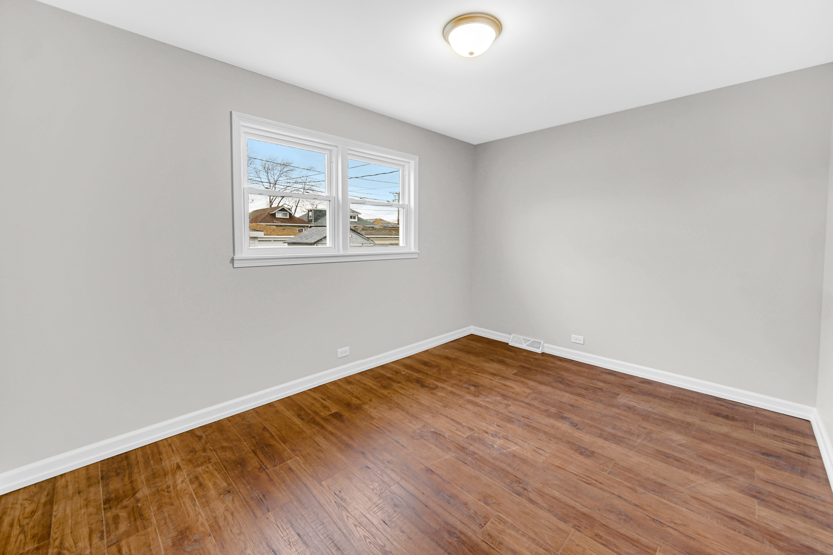 10328 South Union Avenue Chicago, IL 60628 - Photo 10 of 18 an empty room with wooden floor and windows