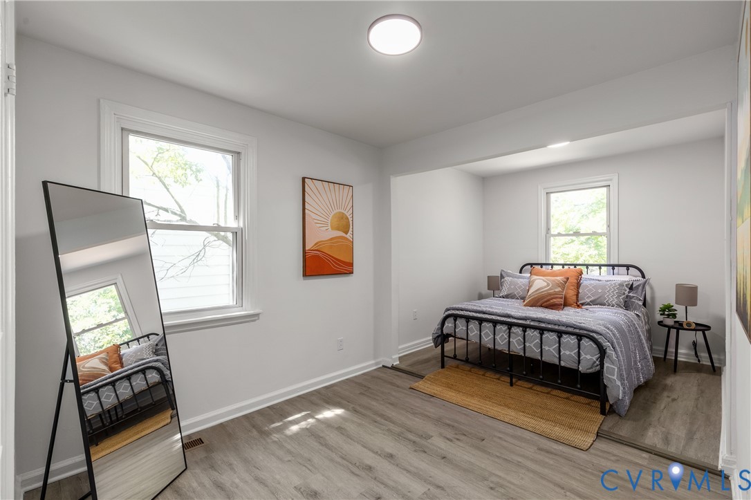 3406 Meadowbridge Road Richmond, VA 23222 - Photo 24 of 41 a bedroom with a bed and wooden floor