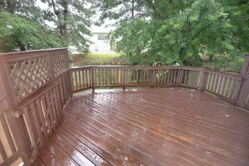 a view of deck with wooden floor and fence