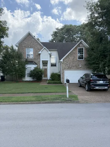 a house view with a garden space and street view