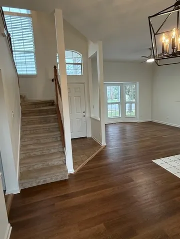 a view of an entryway with wooden floor and stairs
