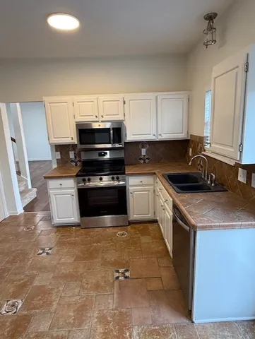 a kitchen with a stove and a sink