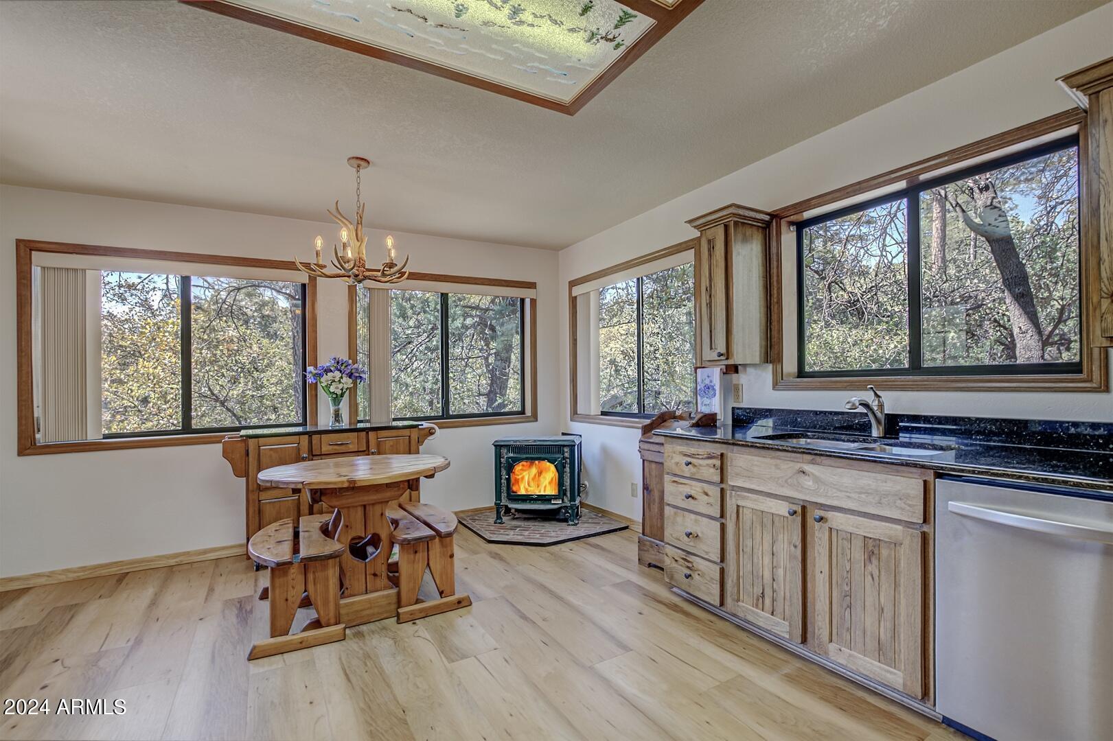6010 Arroyo Way Pine, AZ 85544 - Photo 12 of 52 a kitchen with stainless steel appliances granite countertop a stove a sink dishwasher and a dining table with wooden cabinet