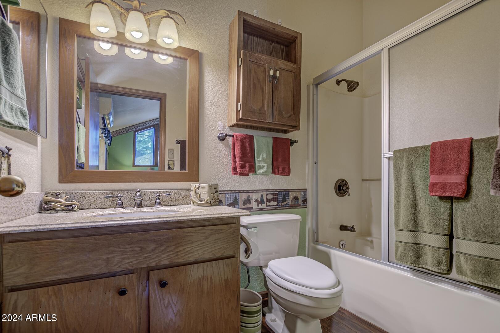 6010 Arroyo Way Pine, AZ 85544 - Photo 17 of 52 a bathroom with a sink toilet vanity and shower