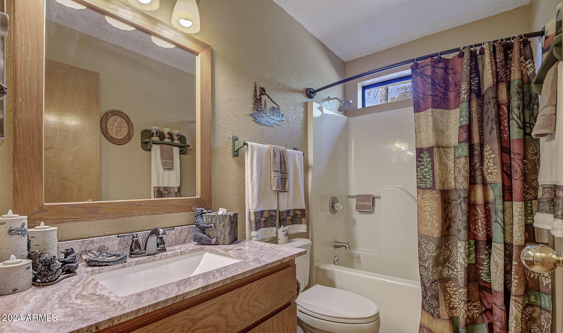 6010 Arroyo Way Pine, AZ 85544 - Photo 23 of 52 a bathroom with a granite countertop sink toilet and shower