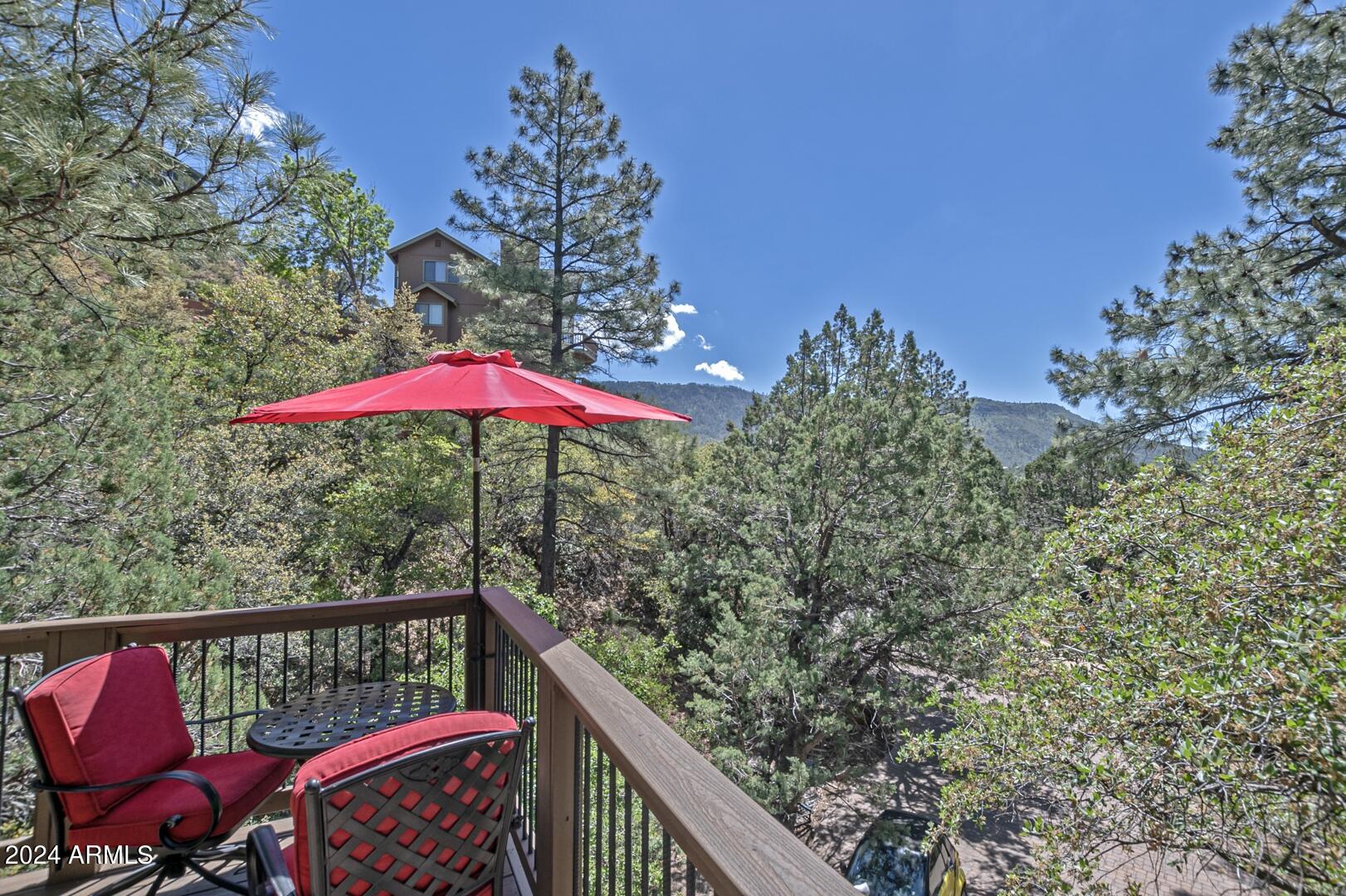 6010 Arroyo Way Pine, AZ 85544 - Photo 36 of 52 a view of balcony with furniture and umbrella