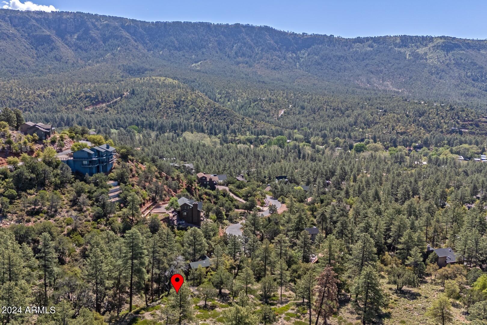 6010 Arroyo Way Pine, AZ 85544 - Photo 48 of 52 a view of a house with a mountain and a forest