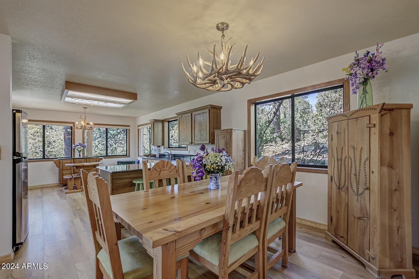 6010 Arroyo Way Pine, AZ 85544 - Photo 8 of 52 a view of a dining room with furniture window and wooden floor