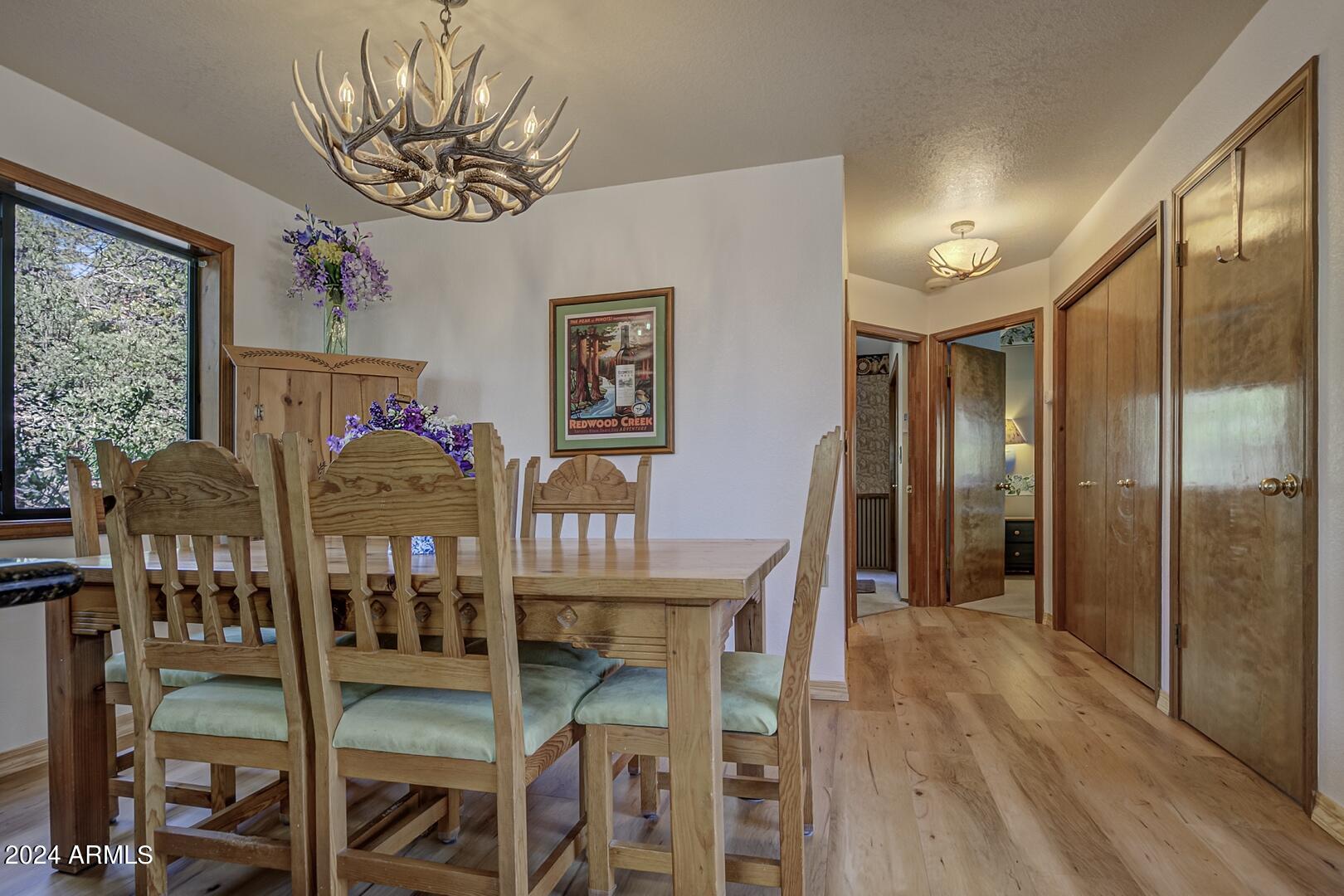 6010 Arroyo Way Pine, AZ 85544 - Photo 9 of 52 a view of a dining room with furniture window and wooden floor