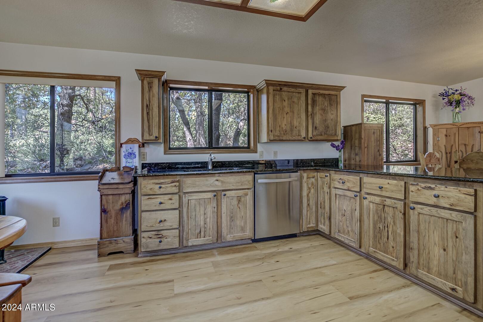 6010 Arroyo Way Pine, AZ 85544 - Photo 10 of 52 a kitchen with stainless steel appliances granite countertop a stove a sink and a granite counter tops with white cabinets