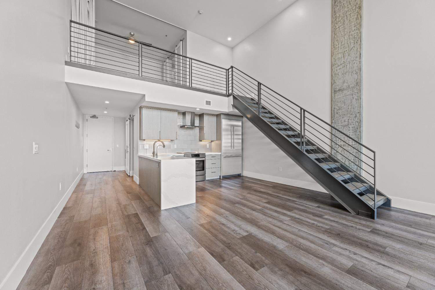 1818 L Street, Unit 807 Sacramento, CA 95811 - Photo 12 of 39 a view of a hallway with wooden floor and staircase