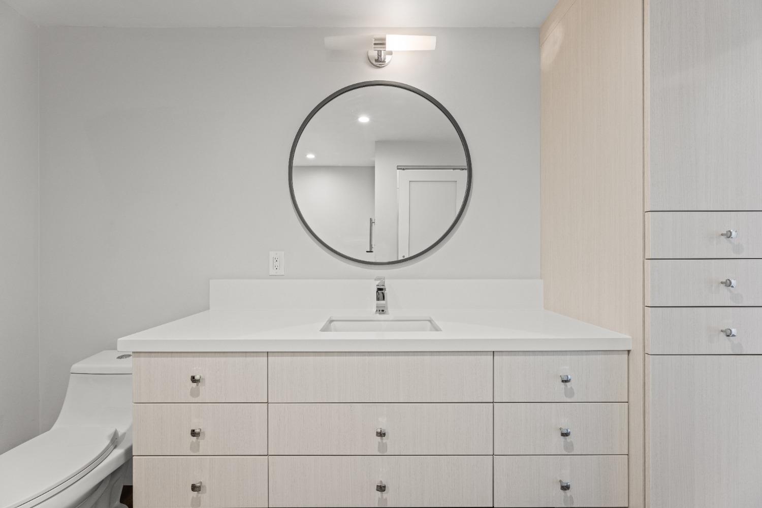 1818 L Street, Unit 807 Sacramento, CA 95811 - Photo 17 of 39 a bathroom with a sink and a mirror