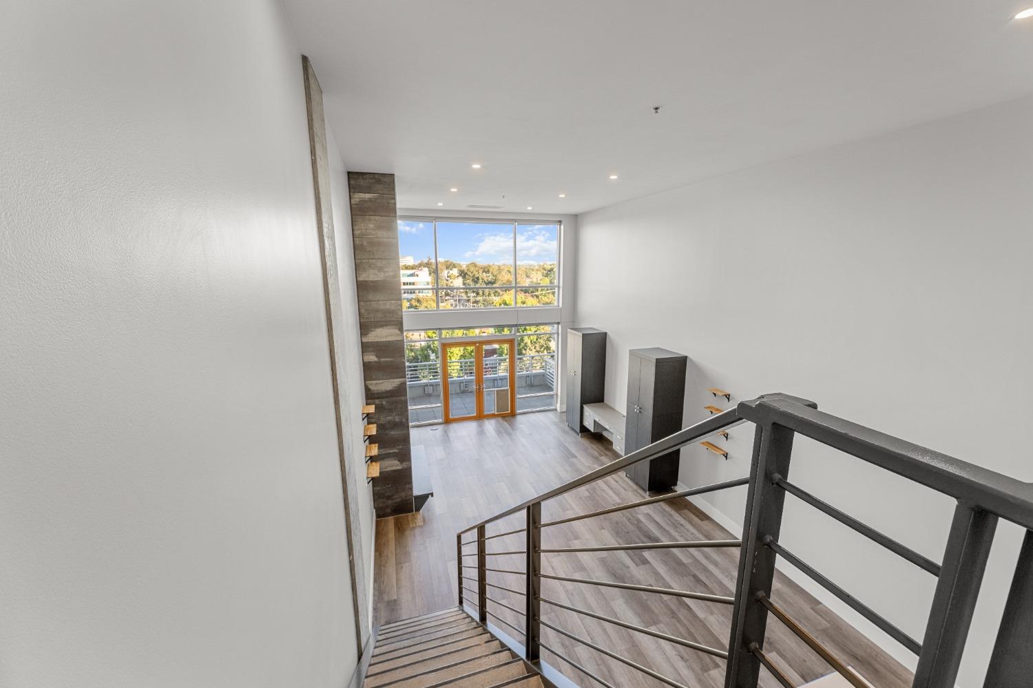 1818 L Street, Unit 807 Sacramento, CA 95811 - Photo 25 of 39 a view of a hallway with wooden floor and stairs