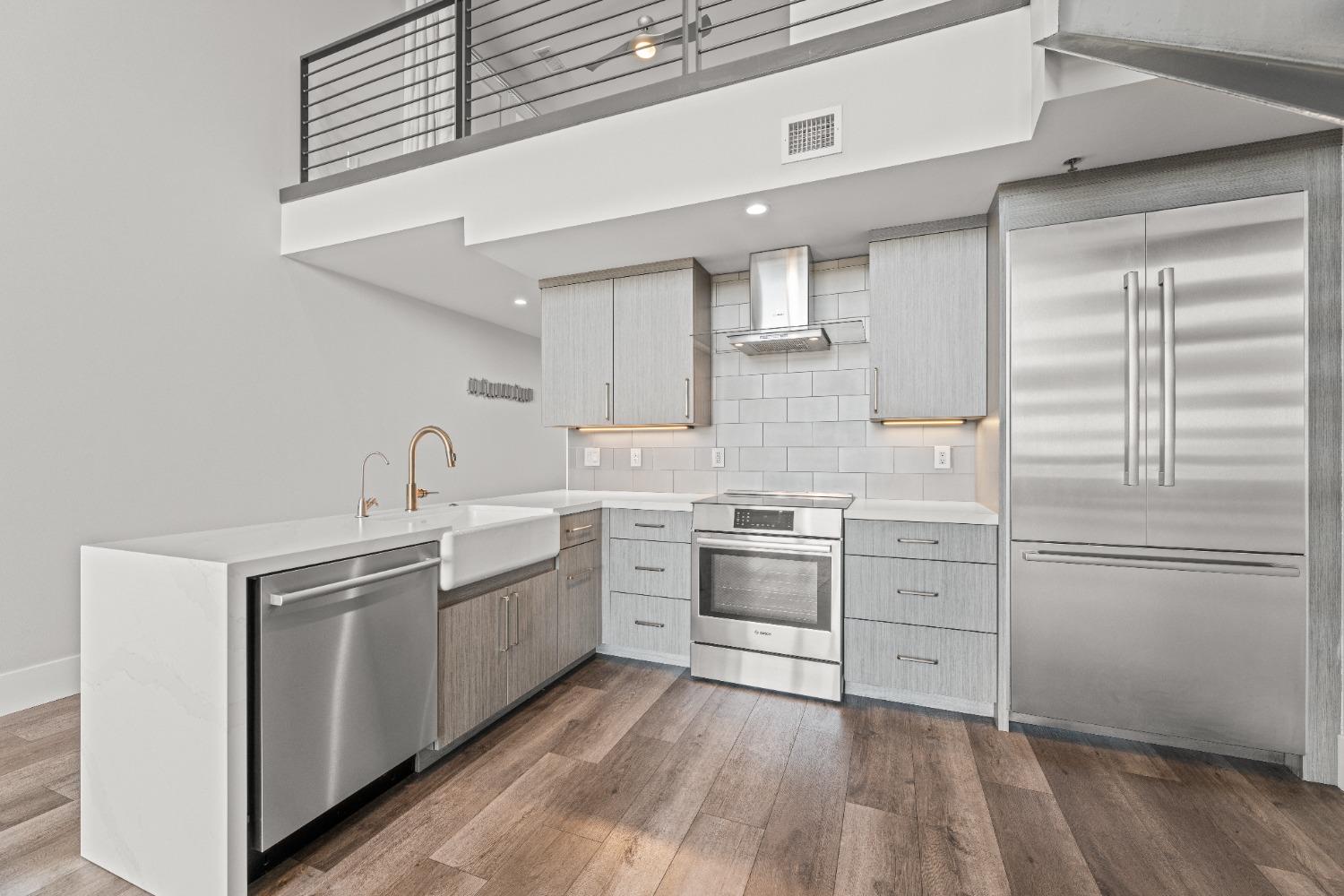 1818 L Street, Unit 807 Sacramento, CA 95811 - Photo 10 of 39 a kitchen with white cabinets stainless steel appliances and sink